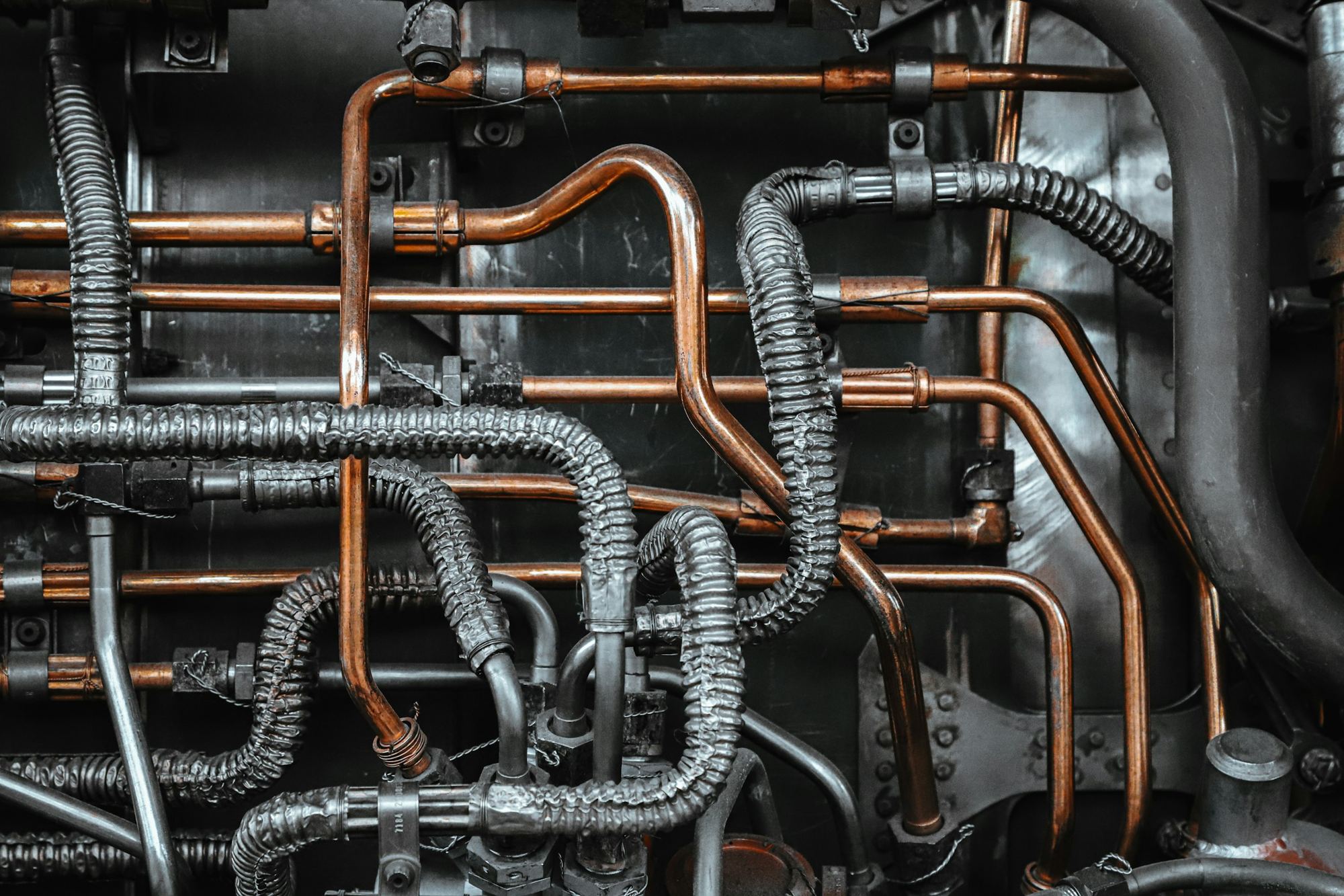 Close-up of copper pipes, braided hoses and brass fittings